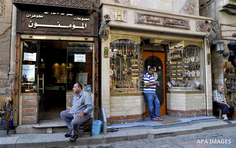 Egyptian vendors stand outside their jewellery store, in cairo, Egypy, on October 19, 2016. Decline in demand for gold in the Egyptian markets due to the high price. Photo by Amr Sayed