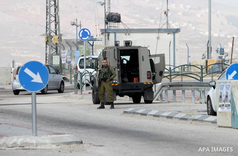 Israeli security forces gather at the site where a Palestinian woman attempted to stab an Israeli border police with a knife before being shot dead, near the Tapuah junction, also known as the Zaatara junction, south of...