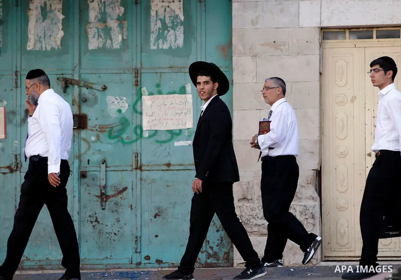 Ultra-Orthodox Jewish visit the Jewish shrine of Atnaeil Ben Kinaz during the Jewish Sukkot holiday or the feast of the Tabernacles in a Palestinian neighbourhood of the divided West Bank city of Hebron on Oct. 19, 2016....
