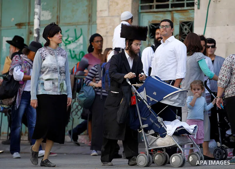Ultra-Orthodox Jewish visit the Jewish shrine of Atnaeil Ben Kinaz during the Jewish Sukkot holiday or the feast of the Tabernacles in a Palestinian neighbourhood of the divided West Bank city of Hebron on Oct. 19, 2016....