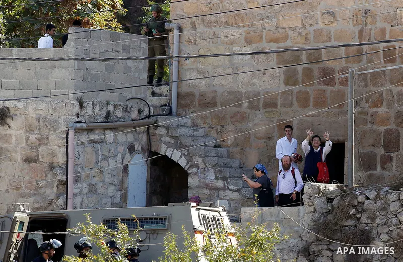 Ultra-Orthodox Jewish visit the Jewish shrine of Atnaeil Ben Kinaz during the Jewish Sukkot holiday or the feast of the Tabernacles in a Palestinian neighbourhood of the divided West Bank city of Hebron on Oct. 19, 2016....