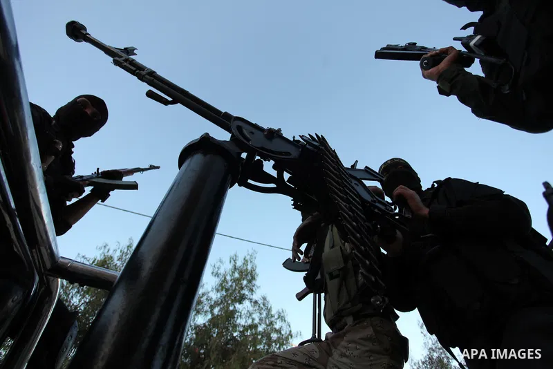 Palestinian Islamic Jihad militants hold their weapons during a military parade marking the 29 anniversary of their group in Gaza October 19, 2016. Photo by Ashraf Amra