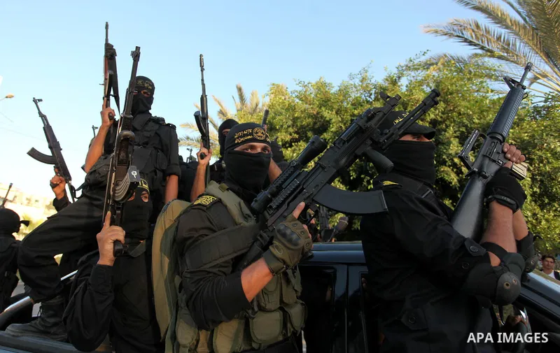 Palestinian Islamic Jihad militants hold their weapons during a military parade marking the 29 anniversary of their group in Gaza October 19, 2016. Photo by Ashraf Amra