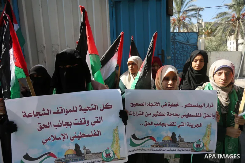 Palestinian Hamas supporters take part in a rally in support of the decision of UNESCO on the Al-Aqsa Mosque in front of the headquarter United Nation "UNSCO", in Gaza city, on October 20, 2016. Palestinian leaders have...