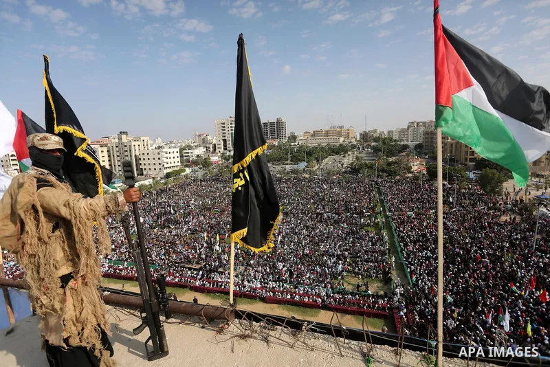 A Palestinian Islamic Jihad militant stands guard on a roof during a rally marking the 29th anniversary of the movement foundation in Gaza City October 21, 2016. Photo by Mohammed Asad