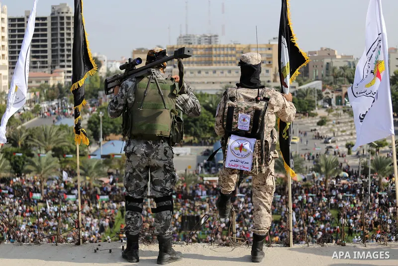 Palestinian Islamic Jihad militants stand guard on a roof during a rally marking the 29th anniversary of the movement foundation in Gaza City October 21, 2016. Photo by Mohammed Asad