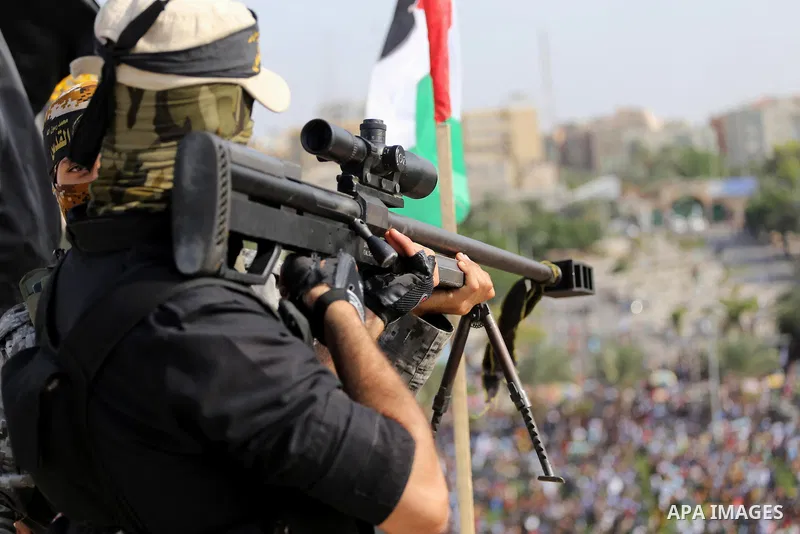 Palestinian Islamic Jihad militant takes up a position on a roof during a rally marking the 29th anniversary of the movement foundation in Gaza City October 21, 2016. Photo by Mohammed Asad