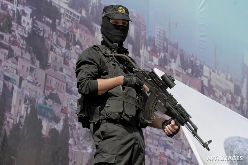 A Palestinian Islamic Jihad militant stands guard during a rally marking the 29th anniversary of the movement foundation in Gaza City October 21, 2016. Photo by Abed Rahim Khatib
