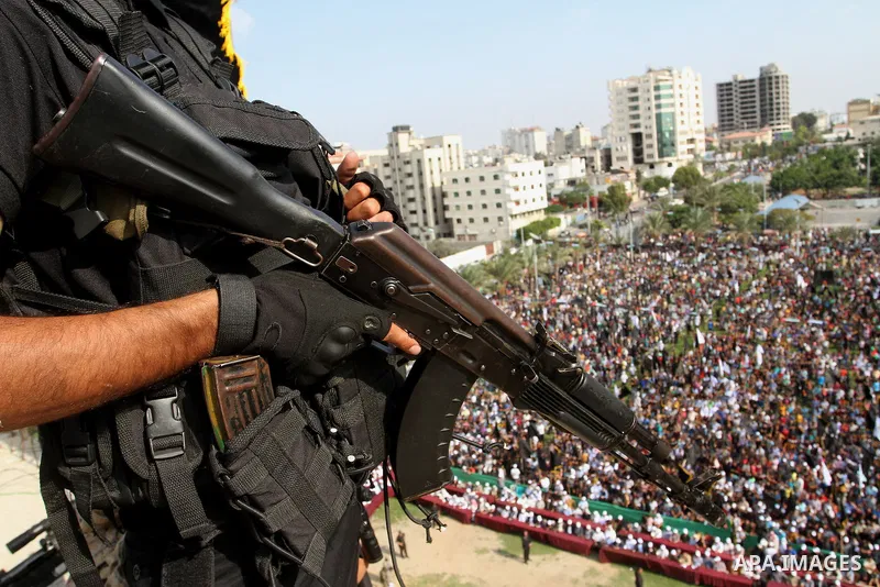 A Palestinian Islamic Jihad militant stands guard on a roof during a rally marking the 29th anniversary of the movement foundation in Gaza City October 21, 2016. Photo by Abed Rahim Khatib