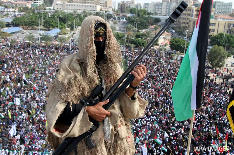 A Palestinian Islamic Jihad militant stands guard on a roof during a rally marking the 29th anniversary of the movement foundation in Gaza City October 21, 2016. Photo by Abed Rahim Khatib