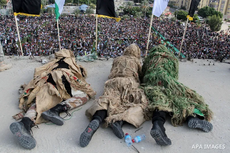 Snipers of Palestinian Islamic Jihad militant take up positions on a roof during a rally marking the 29th anniversary of the movement foundation in Gaza City October 21, 2016. Photo by Abed Rahim Khatib