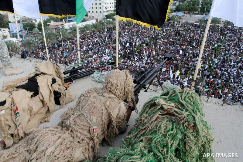 Snipers of Palestinian Islamic Jihad militant take up positions on a roof during a rally marking the 29th anniversary of the movement foundation in Gaza City October 21, 2016. Photo by Abed Rahim Khatib