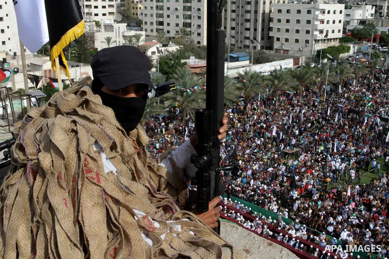 A Palestinian Islamic Jihad militant stands guard on a roof during a rally marking the 29th anniversary of the movement foundation in Gaza City October 21, 2016. Photo by Abed Rahim Khatib