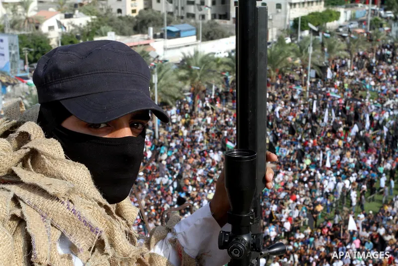 A Palestinian Islamic Jihad militant stands guard on a roof during a rally marking the 29th anniversary of the movement foundation in Gaza City October 21, 2016. Photo by Abed Rahim Khatib