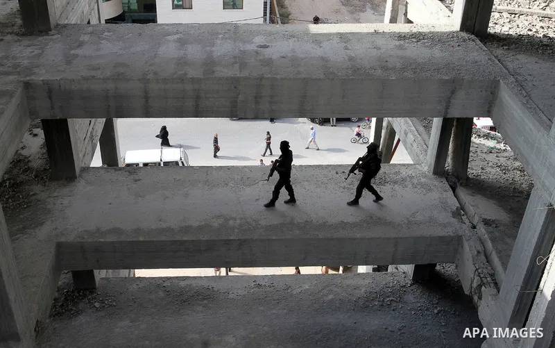 Palestinian Islamic Jihad militants stand guard on a roof during a rally marking the 29th anniversary of the movement foundation in Gaza City October 21, 2016. Photo by Abed Rahim Khatib