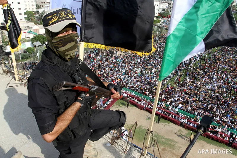 A Palestinian Islamic Jihad militant stands guard on a roof during a rally marking the 29th anniversary of the movement foundation in Gaza City October 21, 2016. Photo by Abed Rahim Khatib
