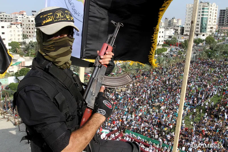 A Palestinian Islamic Jihad militant stands guard on a roof during a rally marking the 29th anniversary of the movement foundation in Gaza City October 21, 2016. Photo by Abed Rahim Khatib