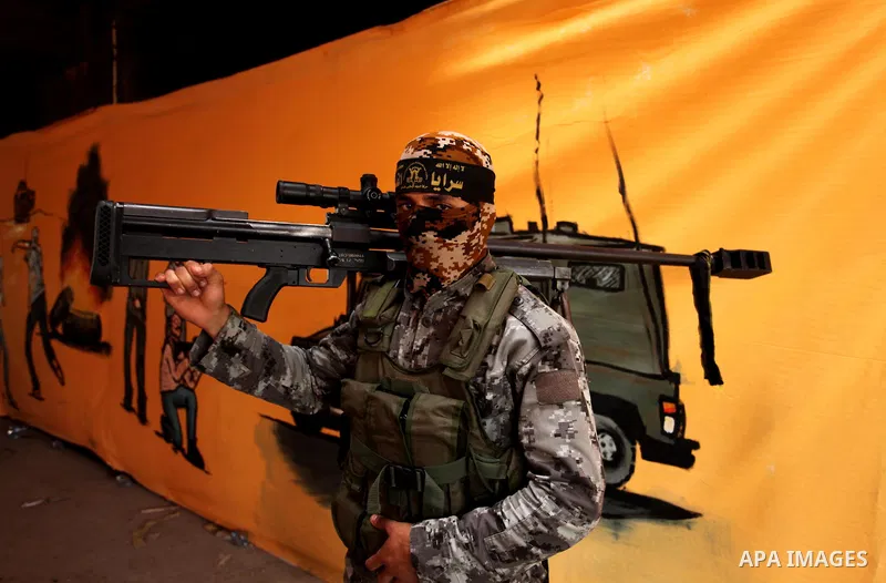 A Palestinian Islamic Jihad militant stands guard during a rally marking the 29th anniversary of the movement foundation in Gaza City October 21, 2016. Photo by Ashraf Amra