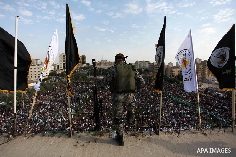 A Palestinian Islamic Jihad militant stands guard on a roof during a rally marking the 29th anniversary of the movement foundation in Gaza City October 21, 2016. Photo by Ashraf Amra