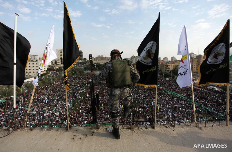 A Palestinian Islamic Jihad militant stands guard on a roof during a rally marking the 29th anniversary of the movement foundation in Gaza City October 21, 2016. Photo by Ashraf Amra