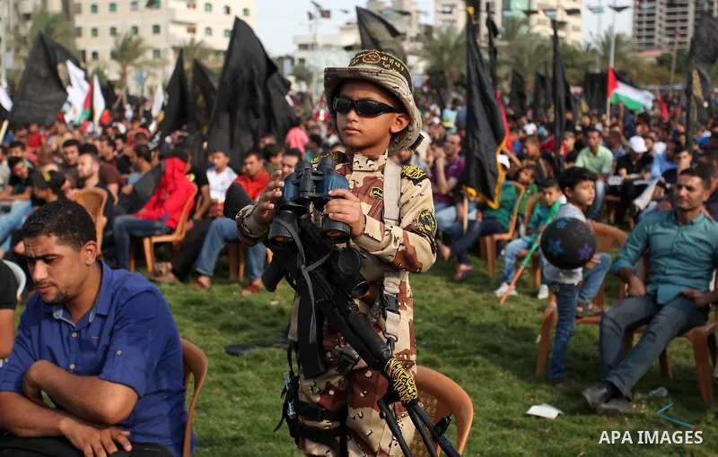 A Palestinian boy attends a rally marking the 29th anniversary of the foundation of the Islamic Jihad movement in Gaza City October 21, 2016. Photo by Ashraf Amra
