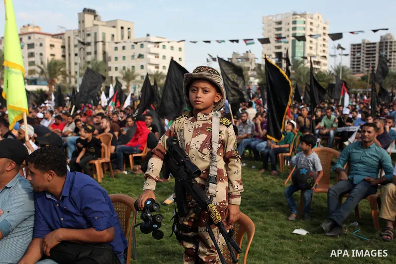 A Palestinian boy attends a rally marking the 29th anniversary of the foundation of the Islamic Jihad movement in Gaza City October 21, 2016. Photo by Ashraf Amra