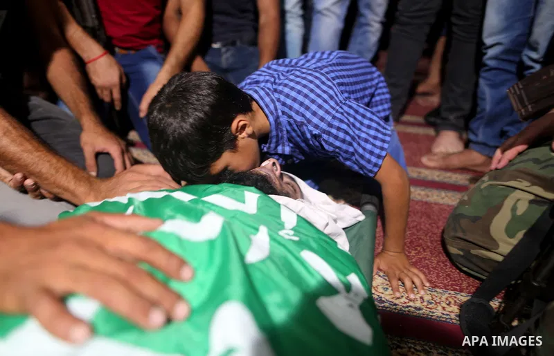 Relatives of a Palestinian member of the Ezzedine al-Qassam Brigades, the armed wing of the Hamas Anas Salama Abu Lasheen, 22, who died after a tunnel collapse in the Gaza Strip mourn during his funeral, in the al-Maghaz...
