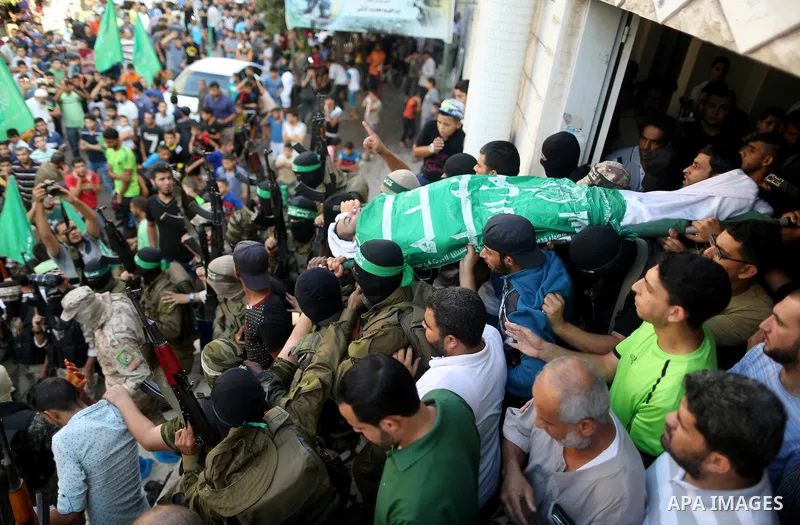 Palestinian members of the Ezzedine al-Qassam Brigades, the armed wing of the Hamas movement carry the body of a Palestinian fellow militant, Anas Salama Abu Lasheen, 22, who died after a tunnel collapse in the Gaza Stri...