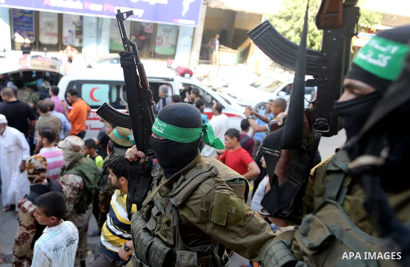 Palestinian members of the Ezzedine al-Qassam Brigades, the armed wing of the Hamas movement take part during the funeral of their fellow militant, Anas Salama Abu Lasheen, 22, who died after a tunnel collapse in the Gaz...