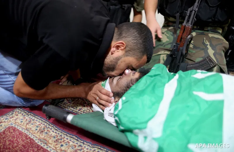 Relatives of a Palestinian member of the Ezzedine al-Qassam Brigades, the armed wing of the Hamas Anas Salama Abu Lasheen, 22, who died after a tunnel collapse in the Gaza Strip mourn during his funeral, in the al-Maghaz...