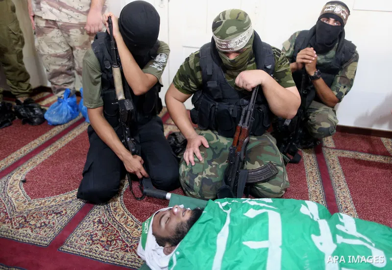 Palestinian members of the Ezzedine al-Qassam Brigades, the armed wing of the Hamas movement mourn during the funeral of their fellow militant, Anas Salama Abu Lasheen, 22, who died after a tunnel collapse in the Gaza St...