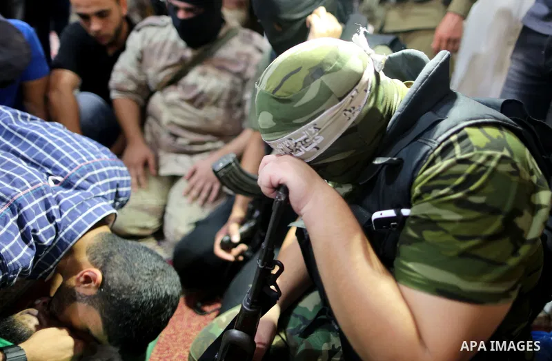 Relatives of a Palestinian member of the Ezzedine al-Qassam Brigades, the armed wing of the Hamas Anas Salama Abu Lasheen, 22, who died after a tunnel collapse in the Gaza Strip mourn during his funeral, in the al-Maghaz...