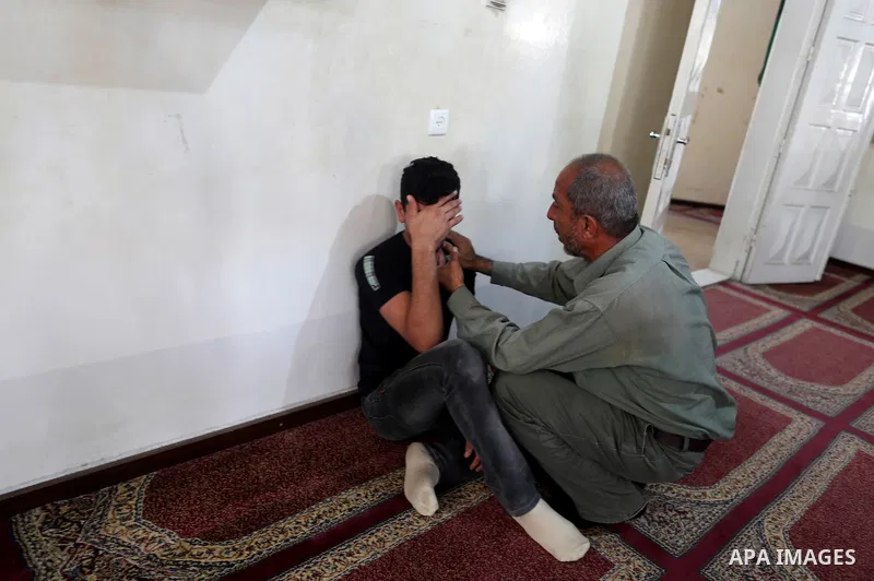 A relative of a Palestinian member of the Ezzedine al-Qassam Brigades, the armed wing of the Hamas Anas Salama Abu Lasheen, 22, who died after a tunnel collapse in the Gaza Strip mourns during his funeral, in the al-Magh...
