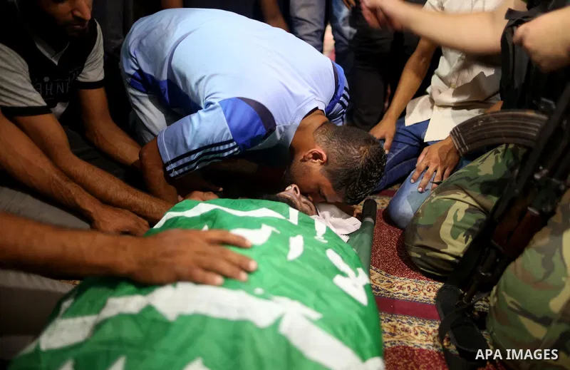 Relatives of a Palestinian member of the Ezzedine al-Qassam Brigades, the armed wing of the Hamas Anas Salama Abu Lasheen, 22, who died after a tunnel collapse in the Gaza Strip mourn during his funeral, in the al-Maghaz...