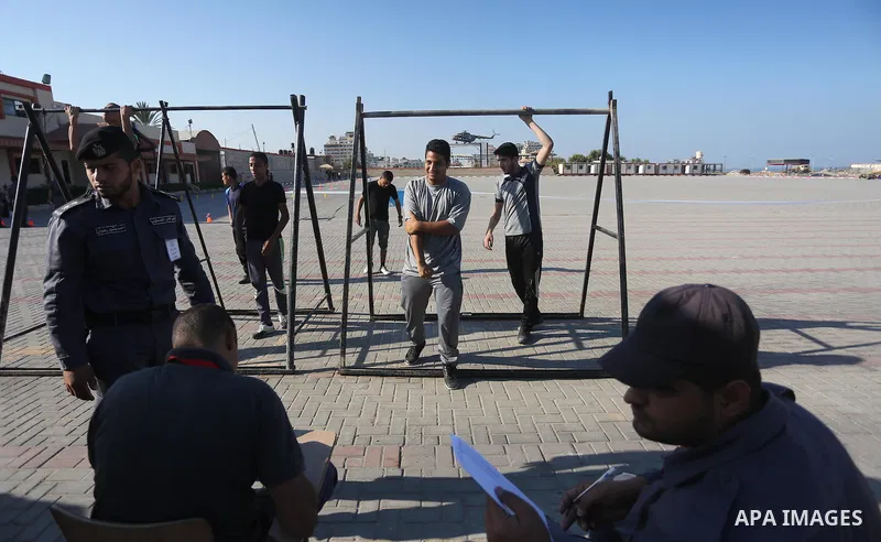 Palestinian applicants undergo a physical examination at a Hamas-run police recruitment centre in Gaza City October 24, 2016. Photo by Mohammed Asad