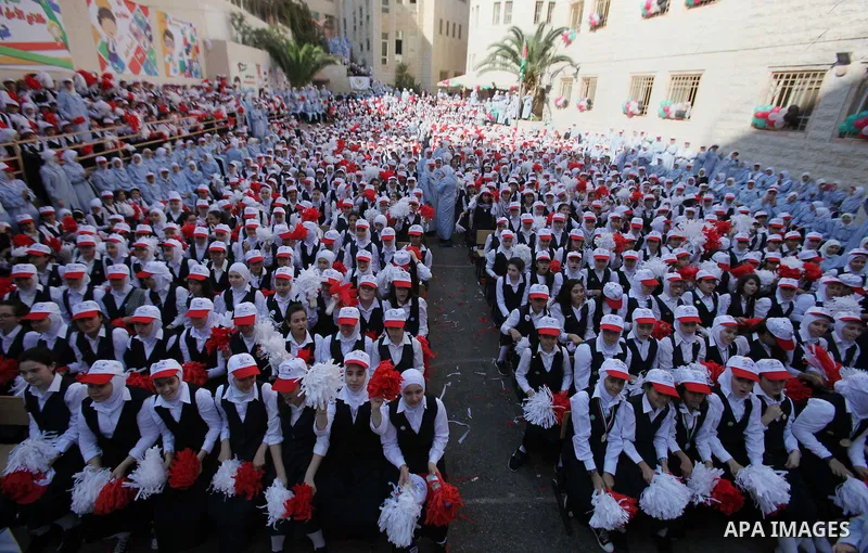 Palestinian students celebrate after winning the Best School Competition "challenge the Arab reading" of the more than 30 thousand schools in the Arab world, in the West Bank city of Nablus, on October 24, 2016. Photo by...