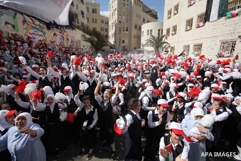 Palestinian students celebrate after winning the Best School Competition "challenge the Arab reading" of the more than 30 thousand schools in the Arab world, in the West Bank city of Nablus, on October 24, 2016. Photo by...