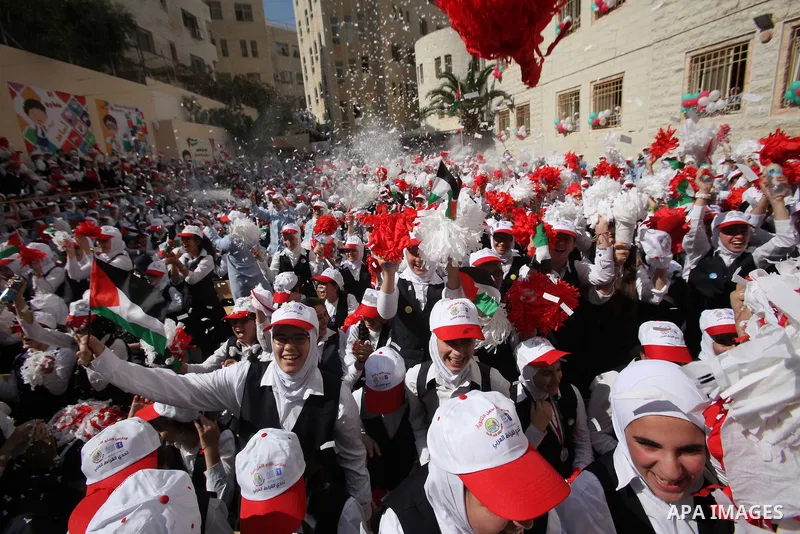 Palestinian students celebrate after winning the Best School Competition "challenge the Arab reading" of the more than 30 thousand schools in the Arab world, in the West Bank city of Nablus, on October 24, 2016. Photo by...