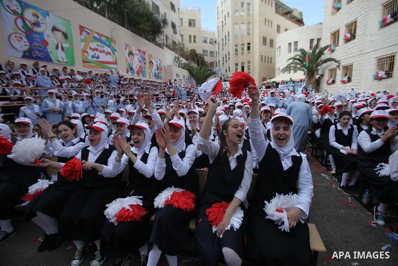 Palestinian students celebrate after winning the Best School Competition "challenge the Arab reading" of the more than 30 thousand schools in the Arab world, in the West Bank city of Nablus, on October 24, 2016. Photo by...