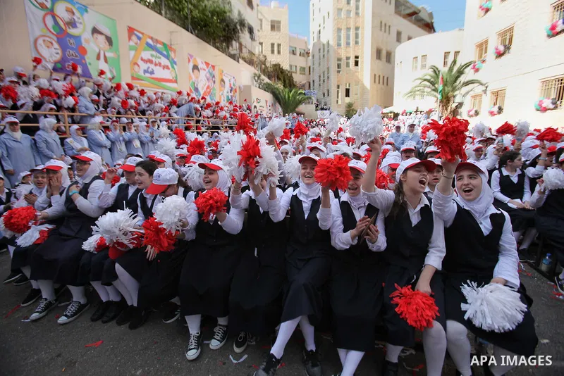 Palestinian students celebrate after winning the Best School Competition "challenge the Arab reading" of the more than 30 thousand schools in the Arab world, in the West Bank city of Nablus, on October 24, 2016. Photo by...