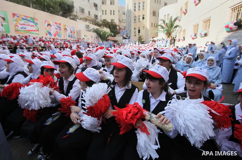 Palestinian students celebrate after winning the Best School Competition "challenge the Arab reading" of the more than 30 thousand schools in the Arab world, in the West Bank city of Nablus, on October 24, 2016. Photo by...