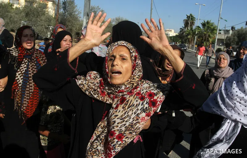 Relatives of Amir Jaber Abu Taimeh, a member of the Ezzedine al-Qassam Brigades, the military wing of the Palestinian Islamist movement Hamas, mourn during his funeral in Khan Yunis in the southern Gaza Strip on October...