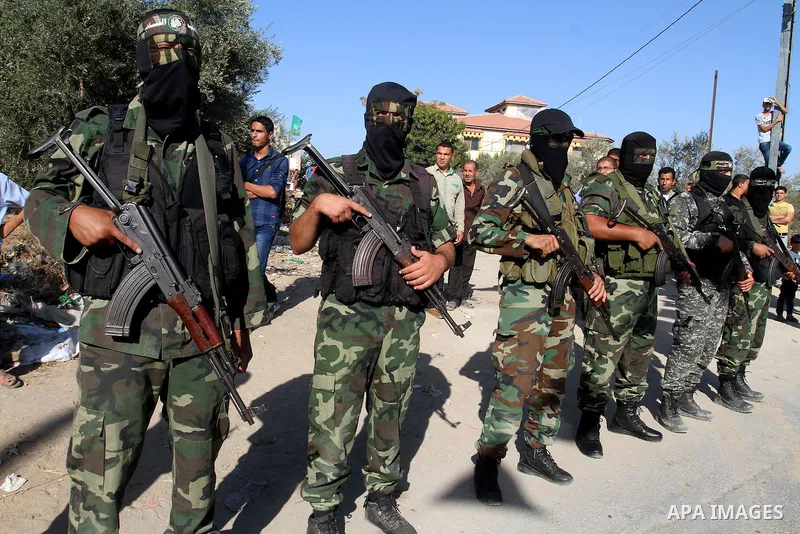Members of the Ezzedine al-Qassam Brigades, the military wing of the Palestinian Islamist movement Hamas, attend the funeral of fellow Palestinian militant Amir Jaber Abu Taimeh in Khan Yunis in the southern Gaza Strip o...