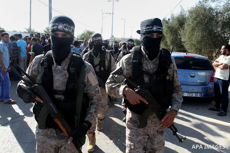 Members of the Ezzedine al-Qassam Brigades, the military wing of the Palestinian Islamist movement Hamas, attend the funeral of fellow Palestinian militant Amir Jaber Abu Taimeh in Khan Yunis in the southern Gaza Strip o...