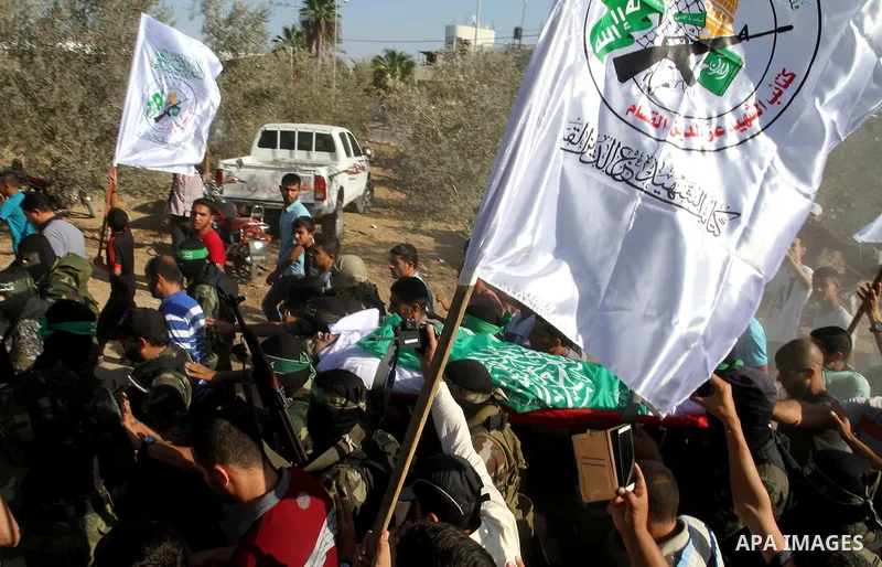 Members of the Ezzedine al-Qassam Brigades, the military wing of the Palestinian Islamist movement Hamas, carry the body of a fellow Palestinian militant, Amir Jaber Abu Taimeh, during his funeral in Khan Yunis in the so...