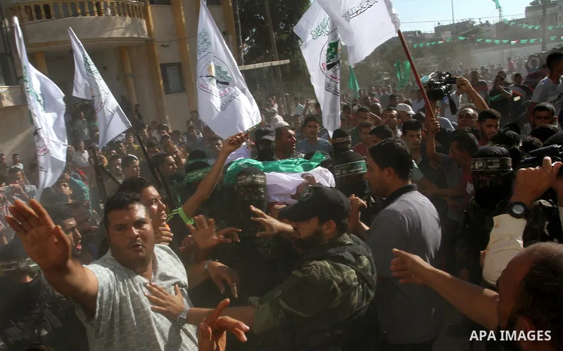 Members of the Ezzedine al-Qassam Brigades, the military wing of the Palestinian Islamist movement Hamas, carry the body of a fellow Palestinian militant, Amir Jaber Abu Taimeh, during his funeral in Khan Yunis in the so...