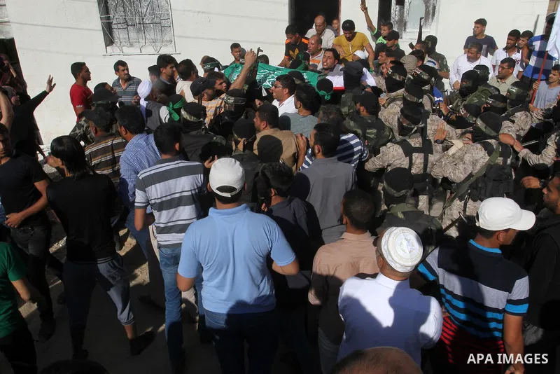 Members of the Ezzedine al-Qassam Brigades, the military wing of the Palestinian Islamist movement Hamas, carry the body of a fellow Palestinian militant, Amir Jaber Abu Taimeh, during his funeral in Khan Yunis in the so...