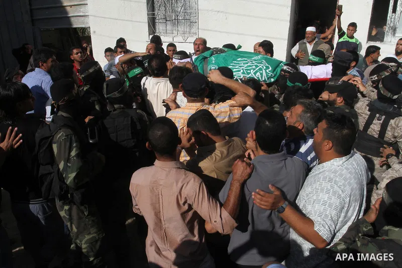Members of the Ezzedine al-Qassam Brigades, the military wing of the Palestinian Islamist movement Hamas, carry the body of a fellow Palestinian militant, Amir Jaber Abu Taimeh, during his funeral in Khan Yunis in the so...