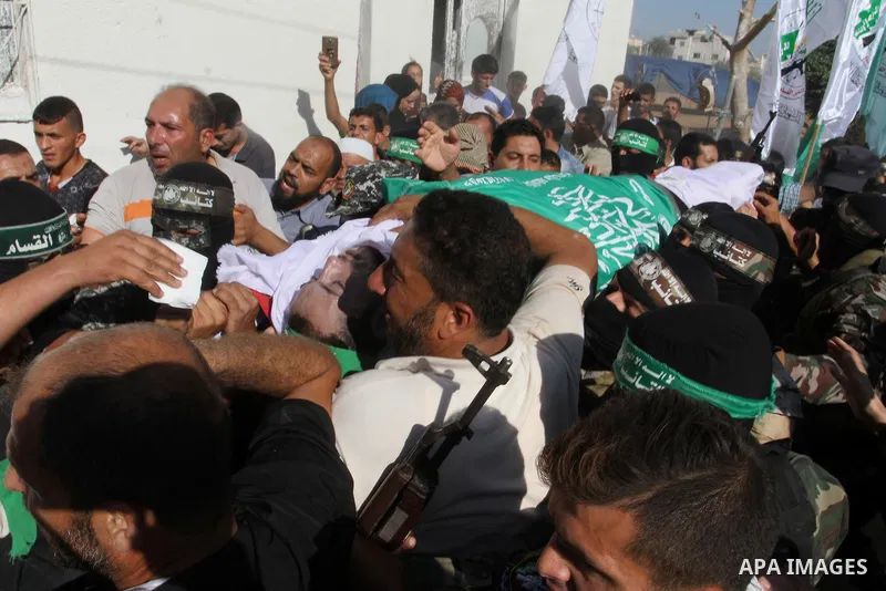 Members of the Ezzedine al-Qassam Brigades, the military wing of the Palestinian Islamist movement Hamas, carry the body of a fellow Palestinian militant, Amir Jaber Abu Taimeh, during his funeral in Khan Yunis in the so...