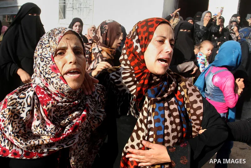 Relatives of Amir Jaber Abu Taimeh, a member of the Ezzedine al-Qassam Brigades, the military wing of the Palestinian Islamist movement Hamas, mourn during his funeral in Khan Yunis in the southern Gaza Strip on October...
